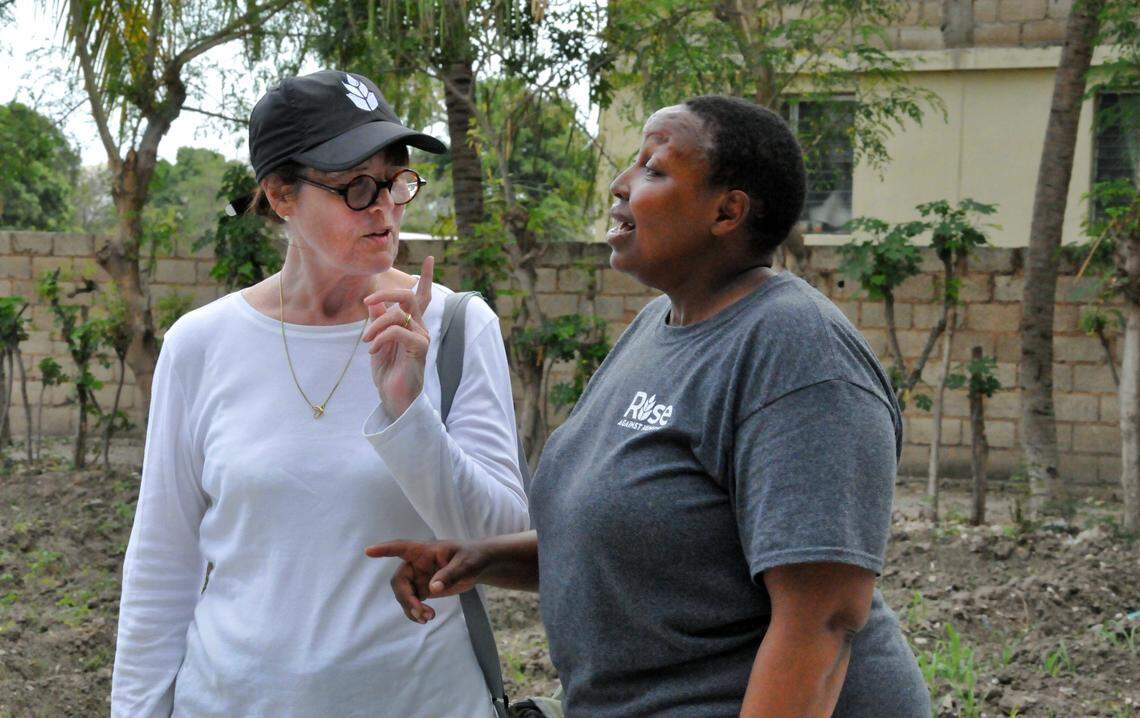 Anne Bander, formerly of Raleigh and chairperson of the Rise Against Hunger board, talks with Edna Ogwangi in the garden at the school In Poteau. "She's just one of those forces of nature," Bander said.