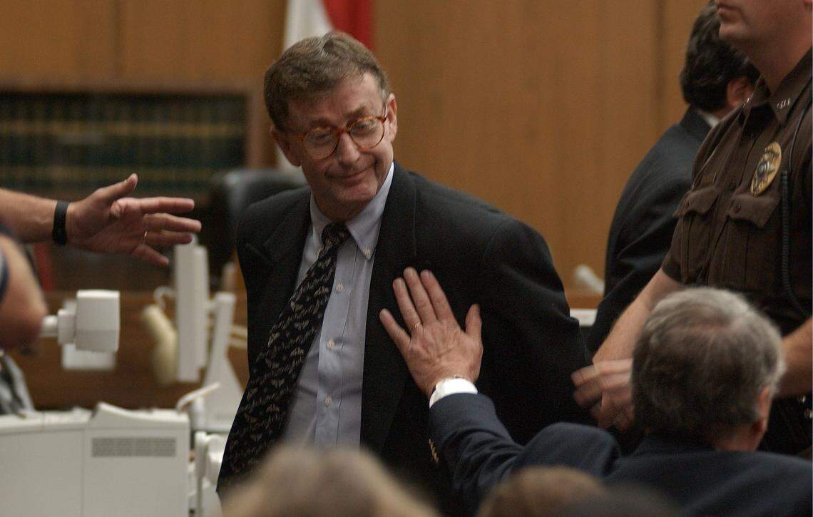 Michael Peterson looks to his family as Durham County Sherrif's deputies lead him away on Oct. 10, 2003, after a jury found him guilty of first degree murder in the death of his wife Kathleen Peterson.
