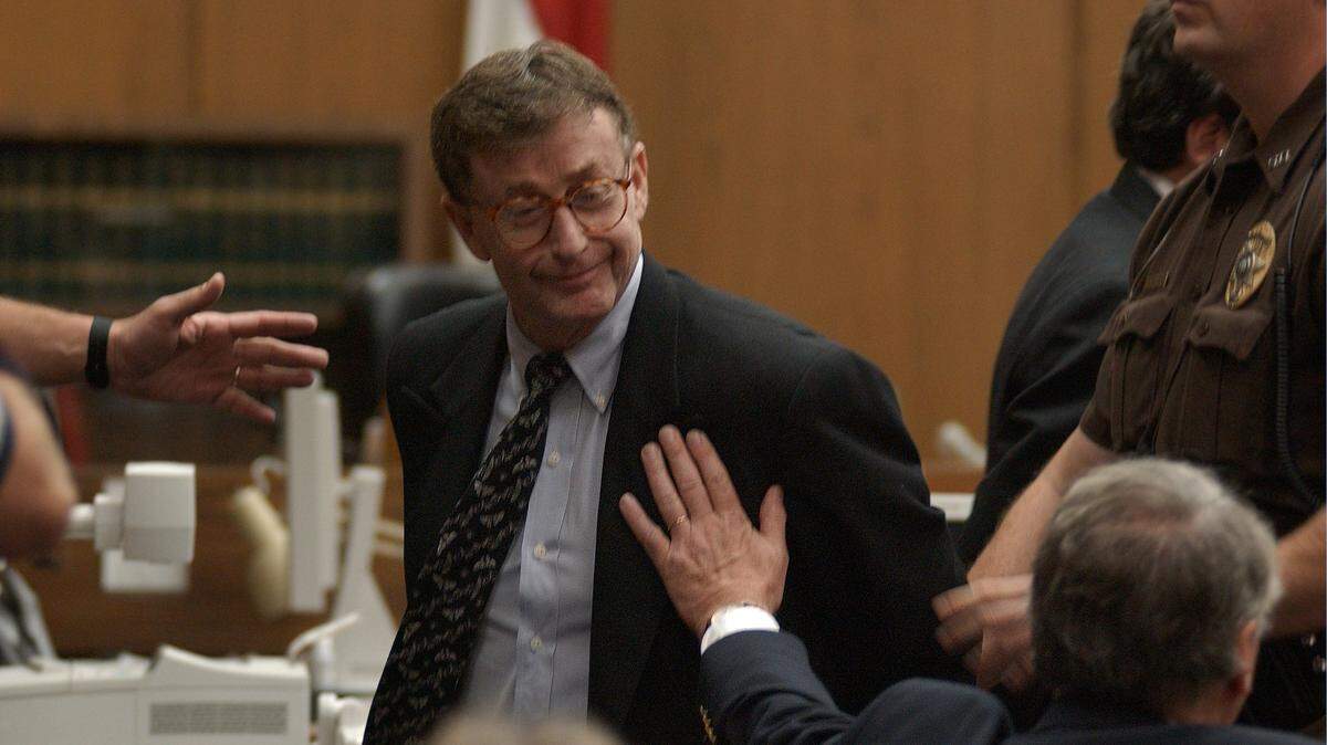 Michael Peterson looks to his family as Durham County Sherrif's deputies lead him away on Oct. 10, 2003, after a jury found him guilty of first degree murder in the death of his wife Kathleen Peterson.