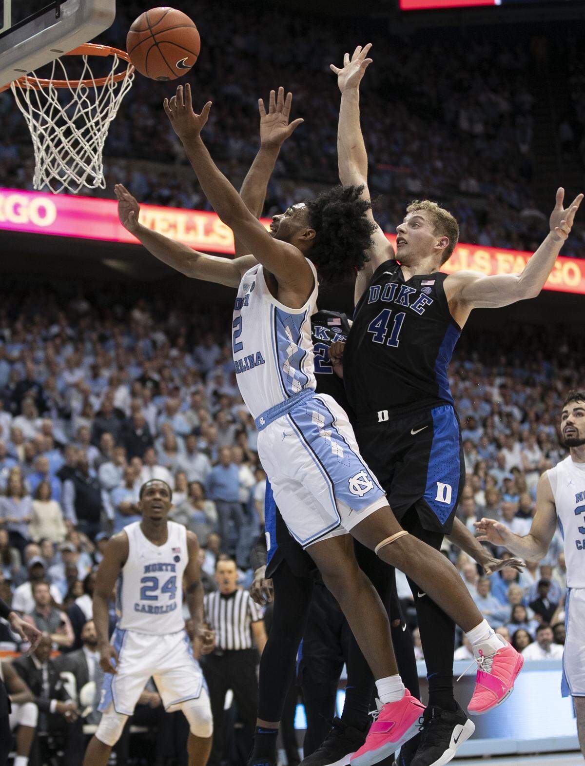 North Carolina’s Coby White (2) drives to the basket against Duke’s Javin DeLaurier (12) and Jack White (41)in the second half on Saturday, March 9, 2019 at the Smith Center in Chapel Hill, N.C. White lead North Carolina with 21 points.