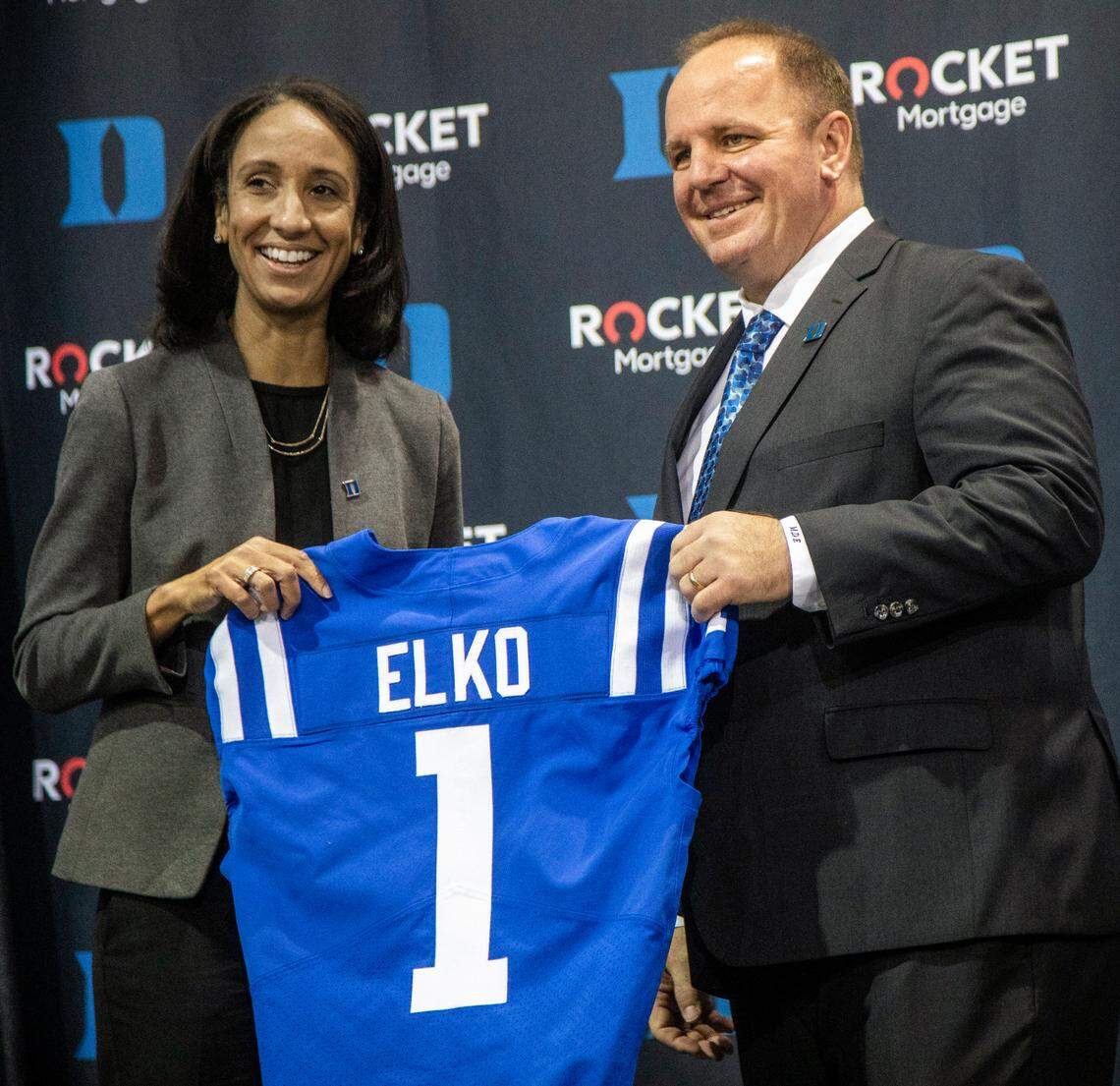 Vice President and Director of Athletics Nina King, left, and†Head Football Coach Mike Elko hold up a Jersey with Elkoís name after he was introduced as Dukeís head football coach during a press conference at Pascal Field House in Durham, Monday, Dec. 13, 2021.