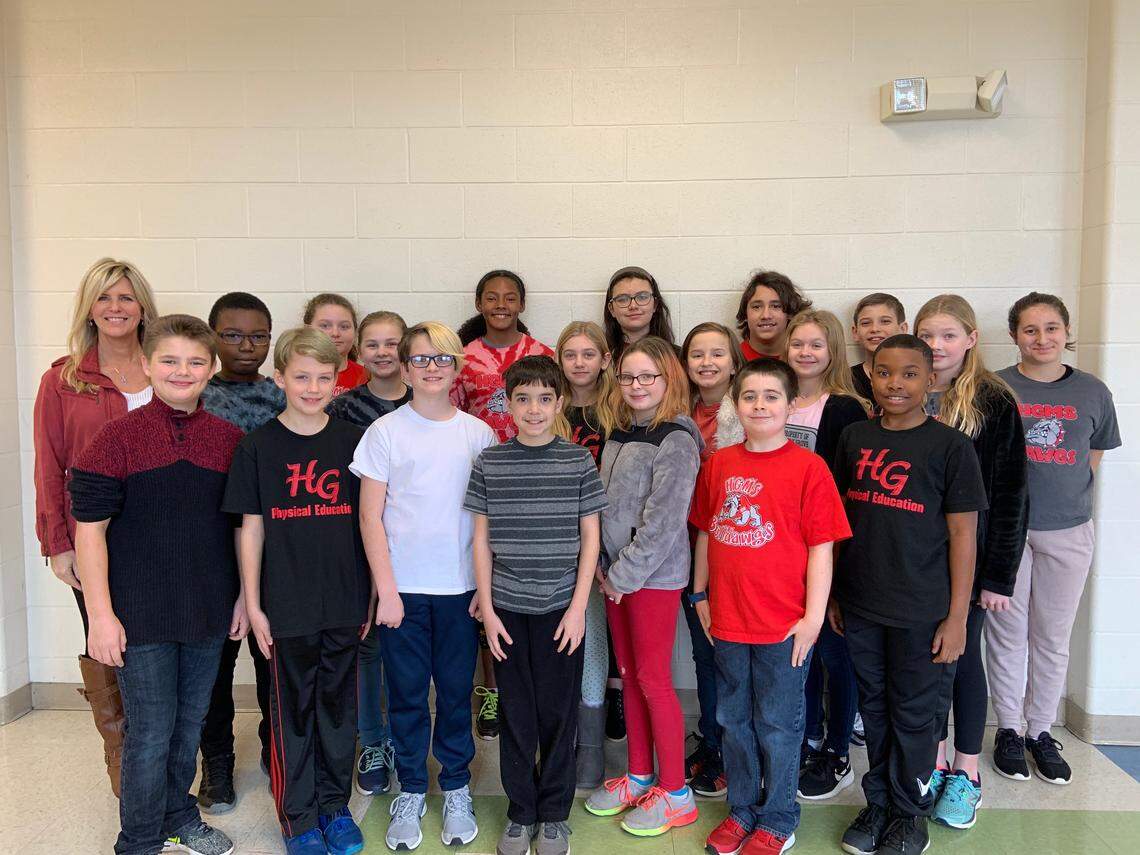 Sixth-grade students at Holly Grove Middle School pose for a picture with science teacher Debbie Schelin. The students were named the North Carolina winner in the Samsung Solve for Tomorrow Contest for their project of creating a sign at school bus stops that would flash to alert people that the bus is about to stop.