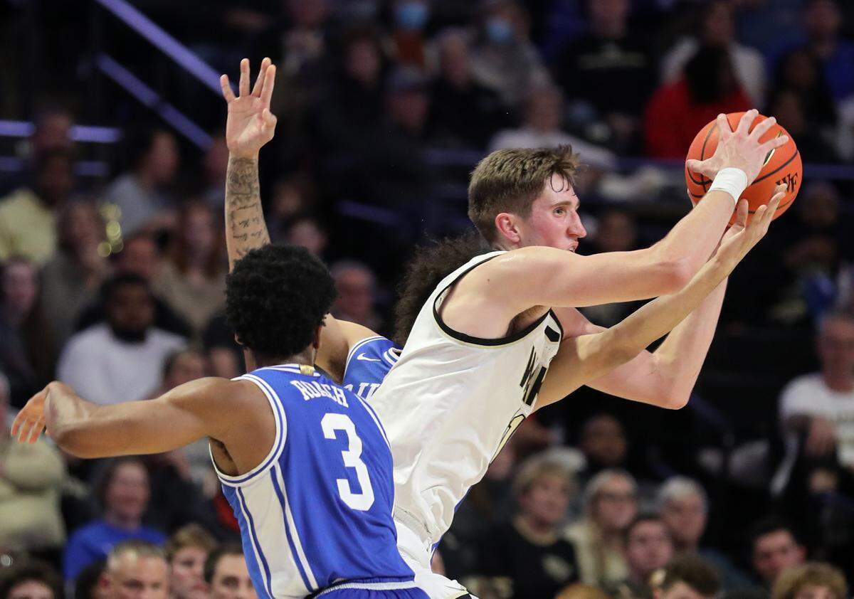 Wake Forest’s Andrew Carr breaks a trap by Duke’s Jeremy Roach and Tyrese Proctor during the second half of a men’s basketball game on Tuesday, Dec. 20, 2022, at Lawrence Joel Veterans Memorial Coliseum in Winston-Salem, N.C.