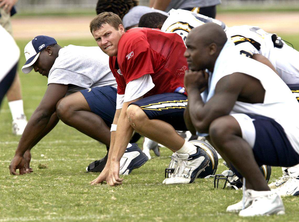 San Diego Chargers rookie quarterback Philip Rivers (center in red jersey) goes through stretching drills with the team at their summer training camp in Carson, Calif, Tuesday, Aug 24, 2004. Rivers ended his lengthy holdout, agreeing to terms on a six-year contract with the Chargers Monday night.