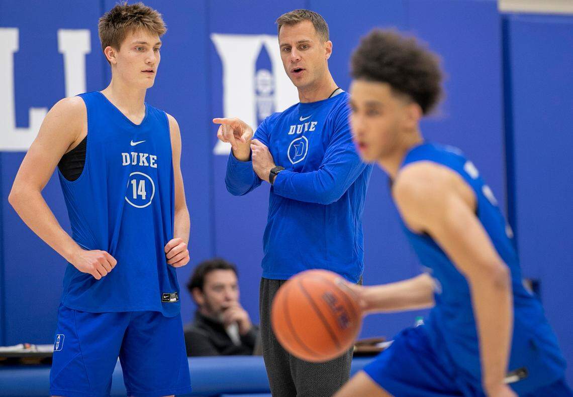 Duke head coach Jon Scheyer talks with Jaden Schutt (14) as he watches Tyrese Proctor (5) during the Blue Devils’ practice on Tuesday, September 27, 2022 in Durham, N.C.