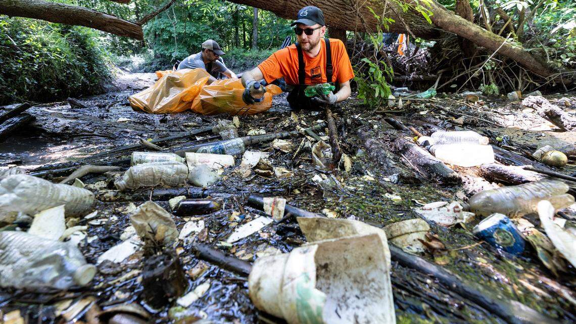 The 2023 North Carolina budget prevents local governments from banning or taxing plastic bags, Styrofoam and other retail containers. Here, volunteer Heath Walajtys collects Styrofoam and other trash as members of the Haw River Assembly and volunteers clean out a trash trap on the Third Fork Creek in Durham, N.C., Saturday, May 25, 2024.
