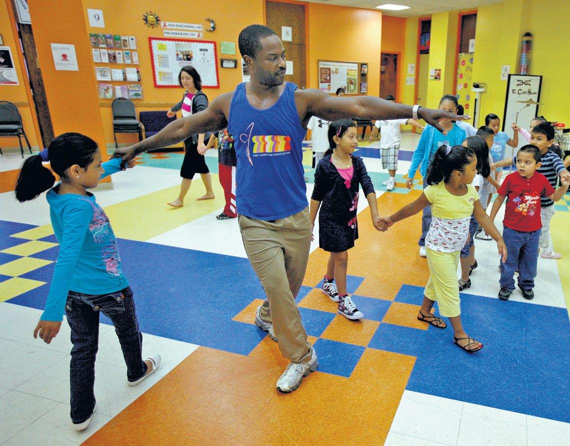 Gaspard Louis, center, former Pilobolus dancer and ADF director of community outreach, teaches kids age 5 to 7 to dance during a workshop at El Centro Hispano in 2009.