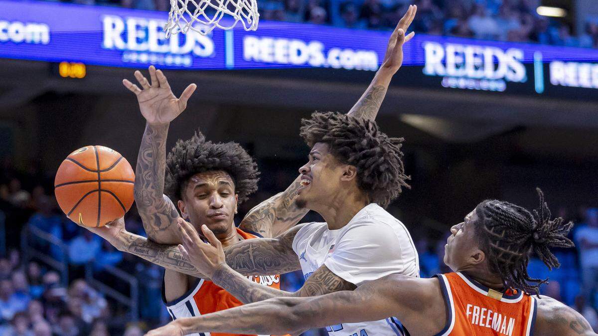 North Carolina guard Jonathan Powell (11) drives to the basket between Syracuse forwards Sadiq White Jr. (0) and Donnie Freeman (1) in the second half on Monday, February 2, 2026 at the Smith Center in Chapel Hill, N.C. 