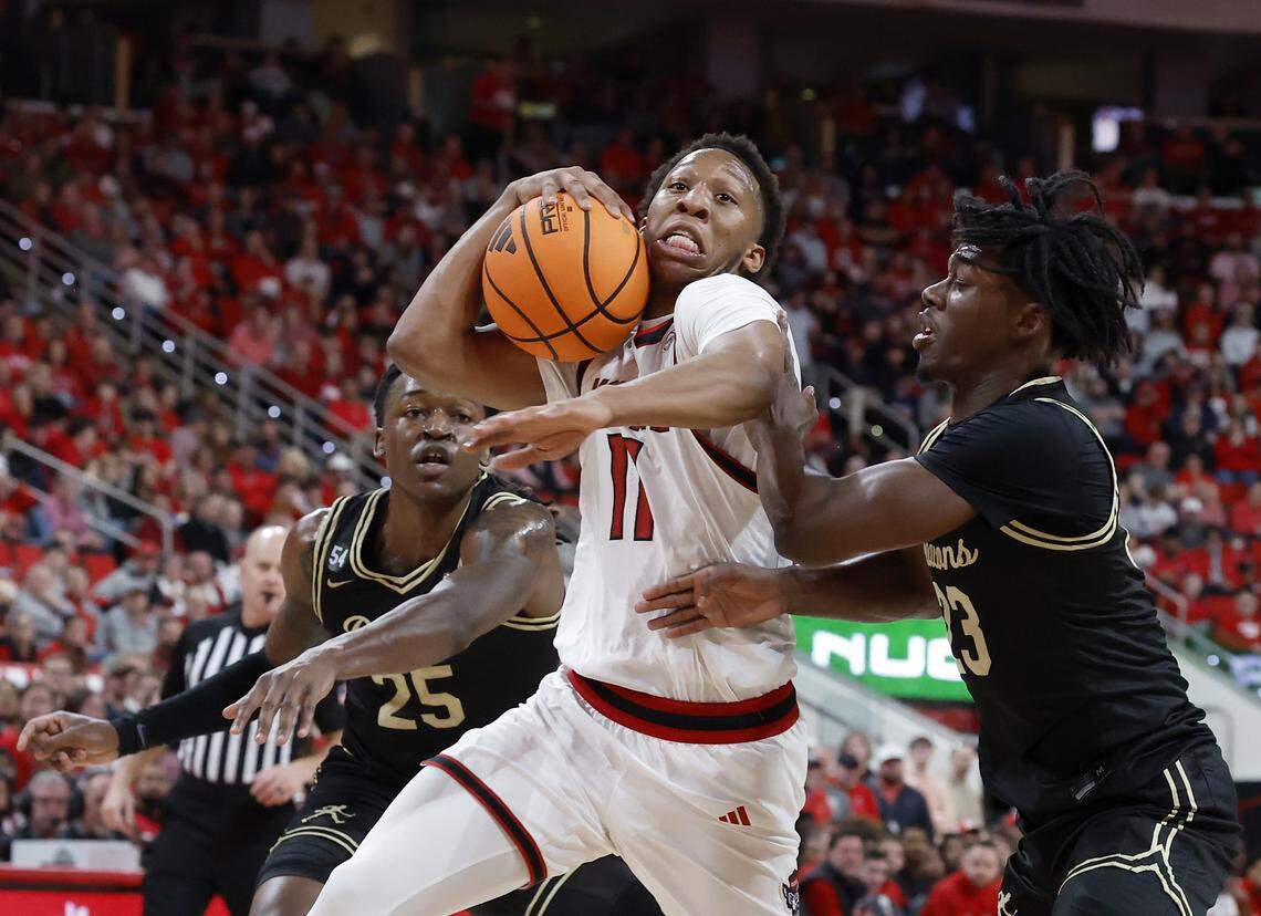 N.C. State’s Quadir Copeland drives past Wake Forest’s Tre’Von Spillers and Jaylen Cross during the first half of the Wolfpack’s game on Wednesday, Dec. 31, 2025, at Lenovo Center in Raleigh, N.C.