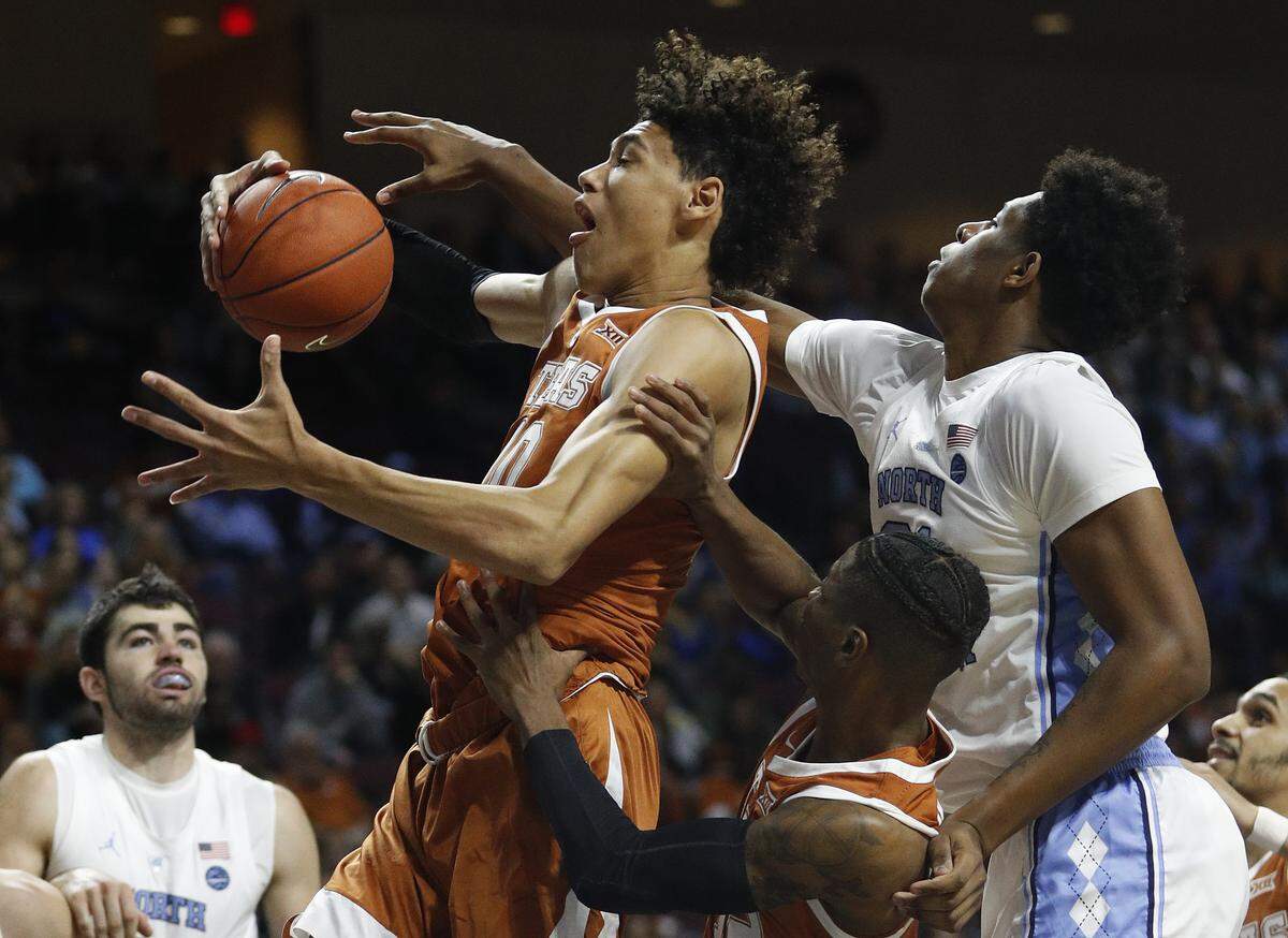 Texas’ Jaxson Hayes (10) grabs a rebound around North Carolina’s Sterling Manley, right, during the first half of an NCAA college basketball game Thursday, Nov. 22, 2018, in Las Vegas.