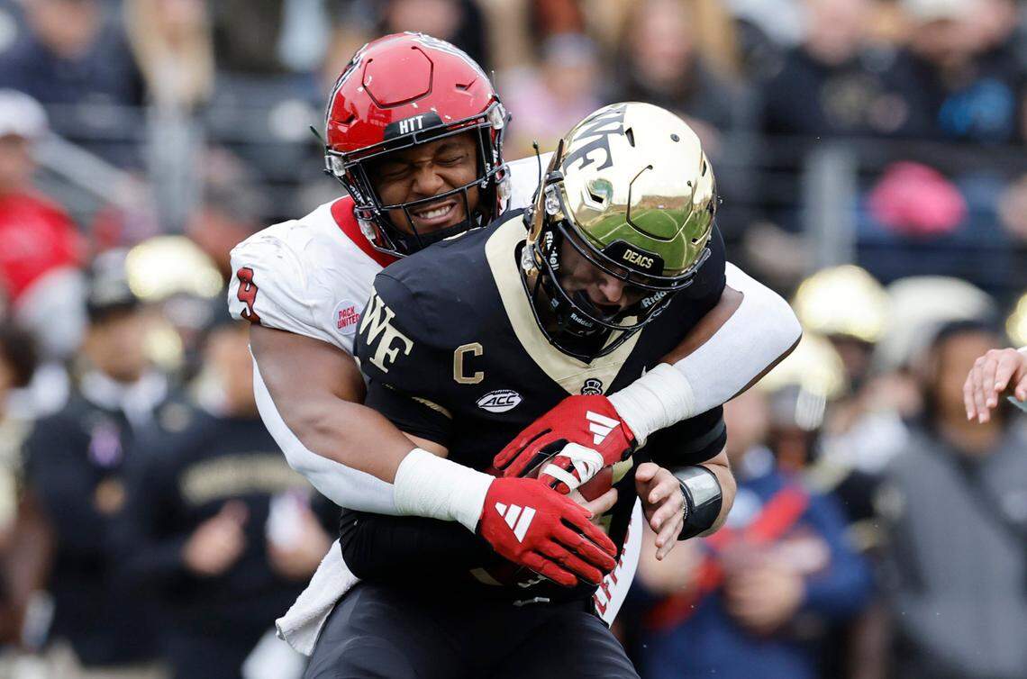 N.C. State defensive end Savion Jackson (9) sacks Wake Forest quarterback Mitch Griffis (12) during the first half of N.C. State’s game against Wake Forest at Allegacy Stadium in Winston-Salem, N.C., Saturday, Nov. 11, 2023.