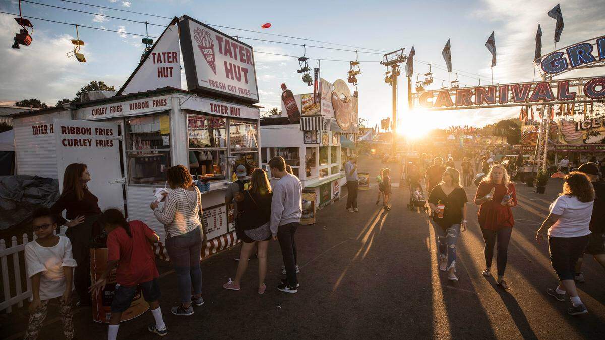The Tater Hut, a popular mom and pop vendor, specializes in fresh-cut french fries. Employees stay busy day and night during the 11-day N.C. State Fair.