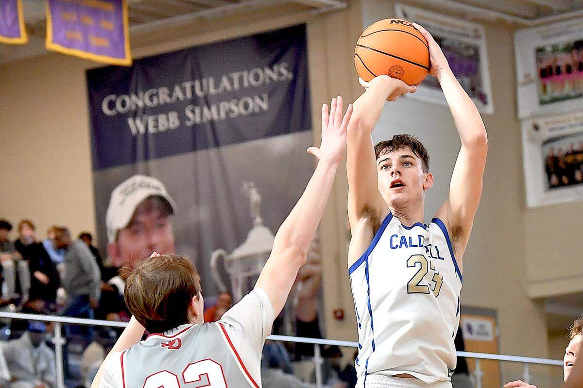 Caldwell Academy guard Cole Cloer (23z0 shoots over Davidson Day center William Stevens (22) during the second half of the John Wall Invitational Tournament. The Davidson Day Patriots and the Caldwell Academy Eagles met in the John Wall Holiday Invitational Tournament in Raleigh, N.C. on December 26, 2024.