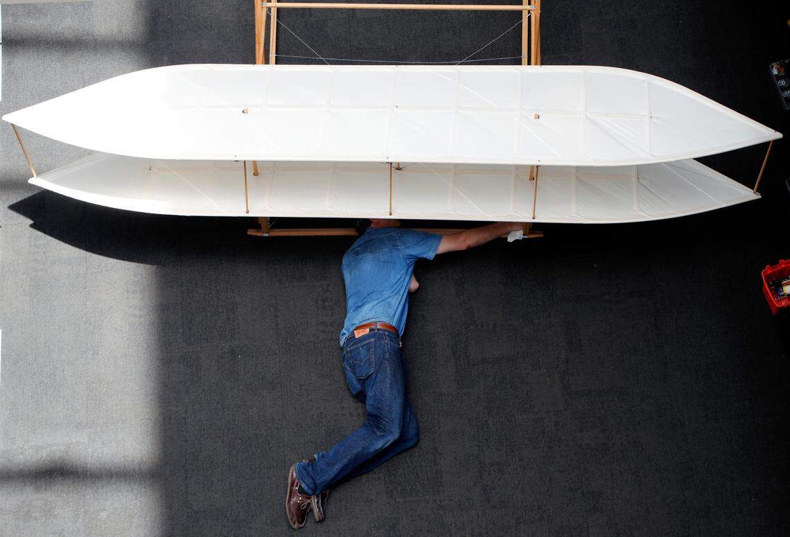 Bill Hadden with the Wright Experience prepares a section of a 1903 Wright Flyer to be moved out at the N.C. Museum of History in Raleigh on June 18, 2018.  They are replacing a replica 1903 Wright Flyer with a replica 1902 Wright Glider at the Museum. The 1902 Glider was the aircraft that was a prelude to the first successful powered flight with the 1903 Flyer.   The 1903 model has been on loan while renovations have been talking place at the Wright Brothers Memorial Visitor Center at Kitty Hawk.