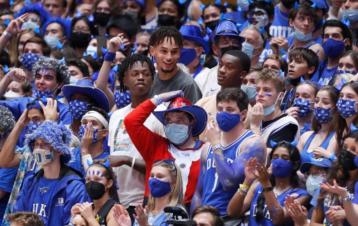 Potential Duke recruit Mark Mitchell, center left, along with recruits Dereck Lively, center, and Dariq Whitehead, right, stand among the Cameron Crazies during Countdown to Craziness at Cameron Indoor Stadium in Durham, N.C., Friday, October 15, 2021.