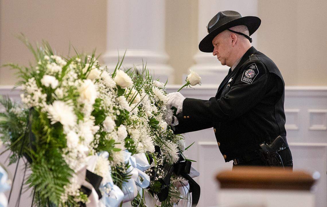 Flowers are placed during the Wake County Law Enforcement Officer Memorial Ceremony on Monday at Hayes Barton Baptist Church in Raleigh. The ceremony, part of National Police Week, honored 23 Wake County fallen officers.