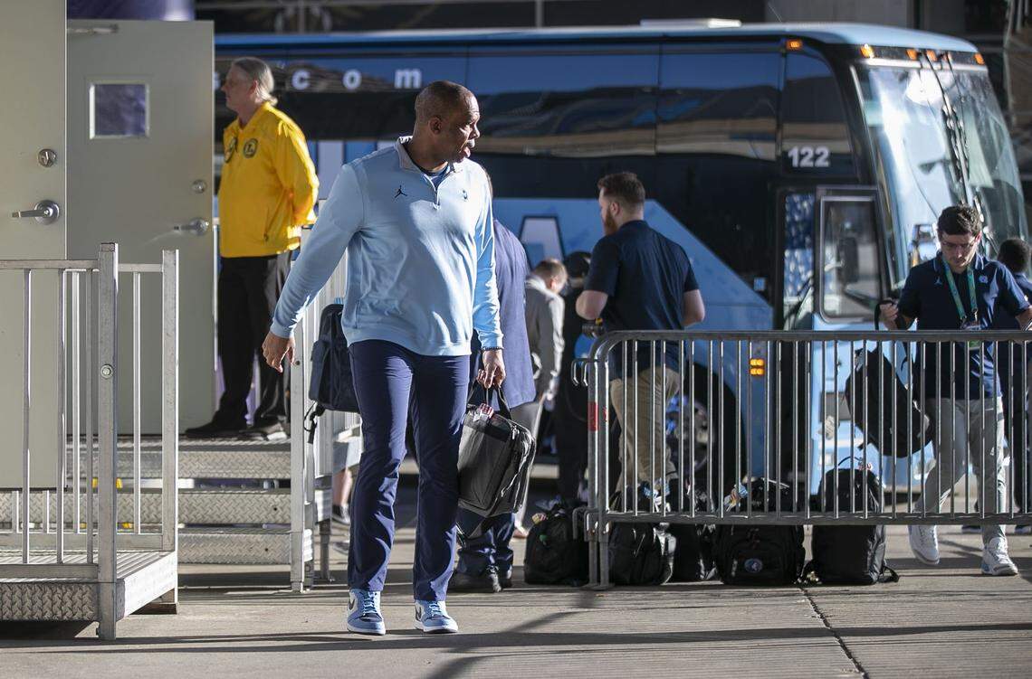 North Carolina coach Hubert Davis is the first off the Tar Heels bus as they arrive for their NCAA Final Four semi-final game against Duke on Saturday, April 2, 2022 at Caesars Superdome in New Orleans, La.