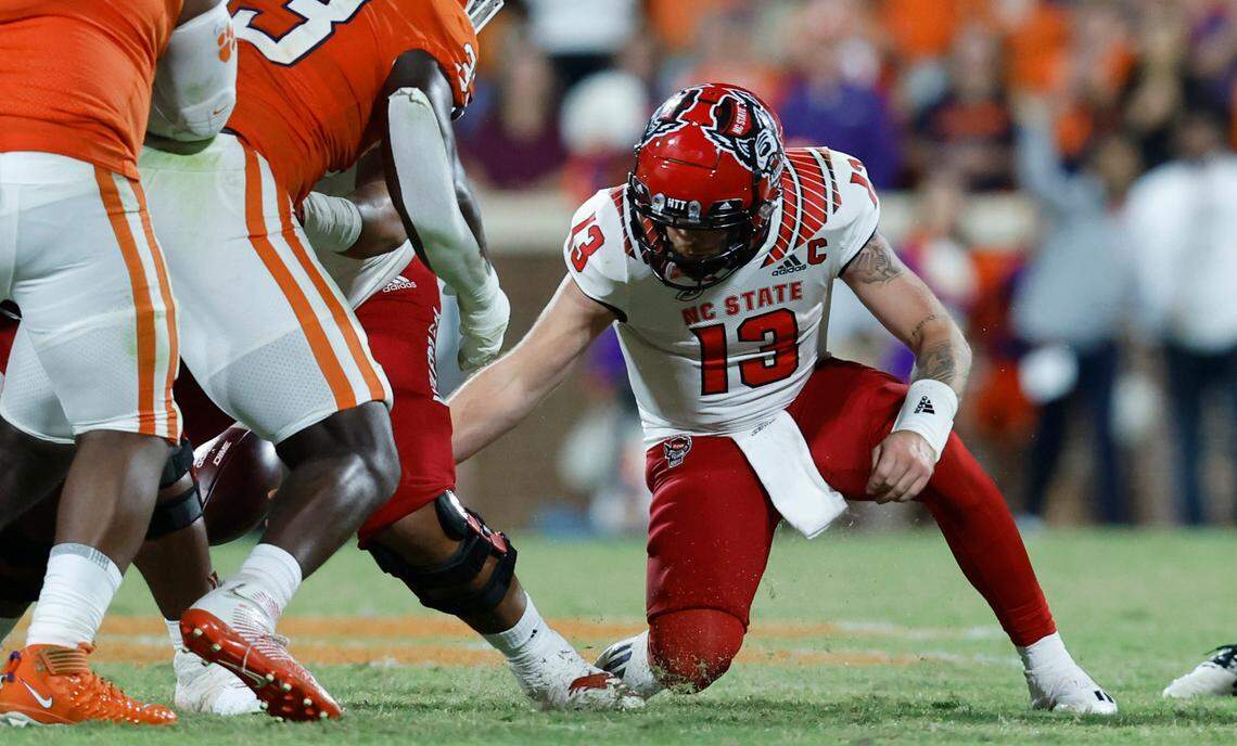 N.C. State quarterback Devin Leary (13) dives after the ball after he couldn’t pull in the snap on fourth down during the second half of Clemson’s 30-20 victory over N.C. State at Memorial Stadium in Clemson, S.C., Saturday, Oct. 1, 2022.
