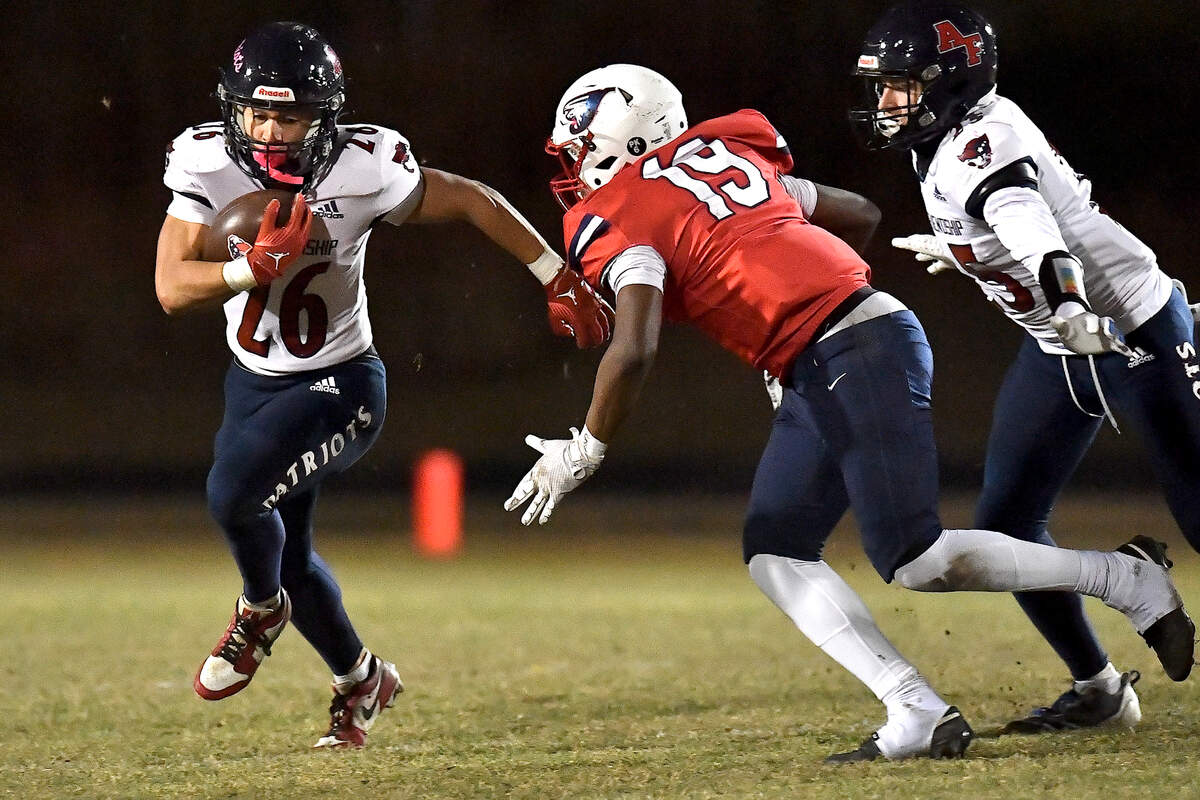 Apex Friendship’s Jaden Avery (26) runs for yardage against Jordan’s Evan Harewood (19) during the first half. The Apex Friendship Patriots and the Durham Jordan Falcons met in the second round of the NCHSAA 4A playoffs in Durham, N.C. on November 22, 2024.