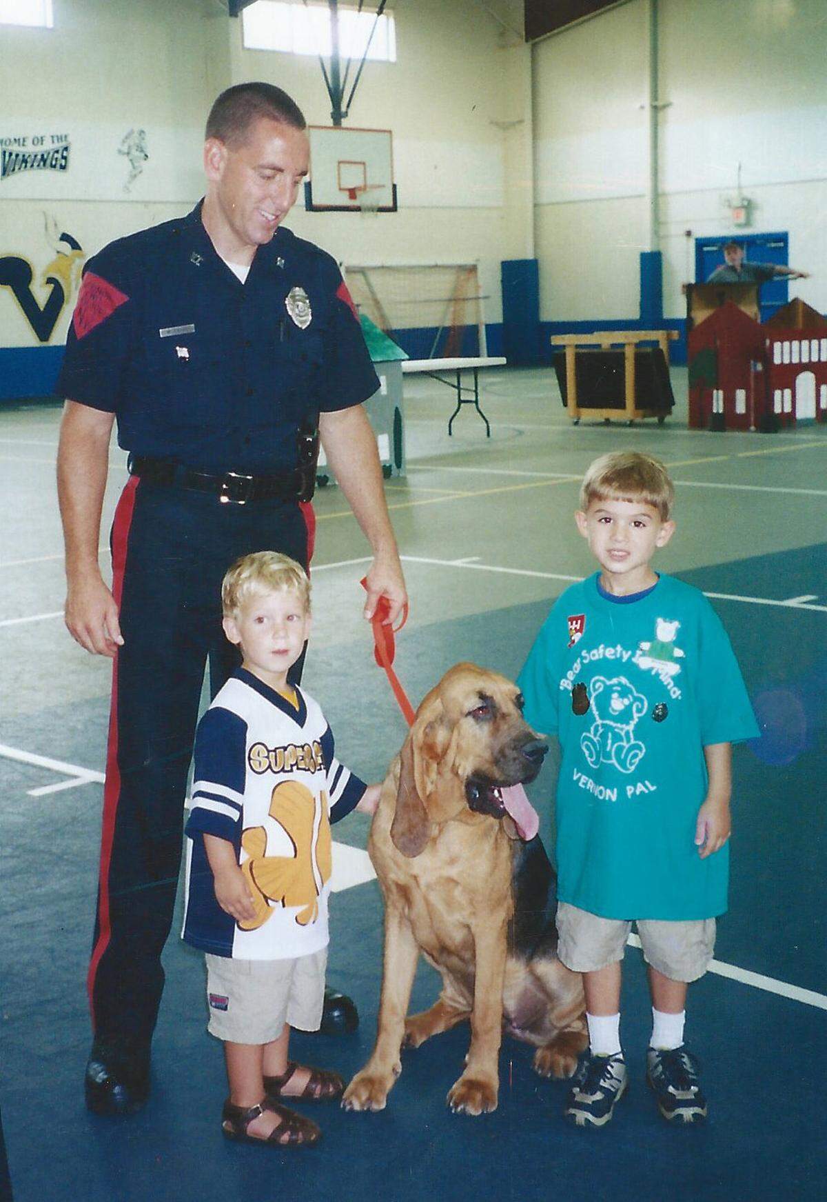 Michael Higgins, right, and his brother Shane, meet a police officer in an undated family photo.