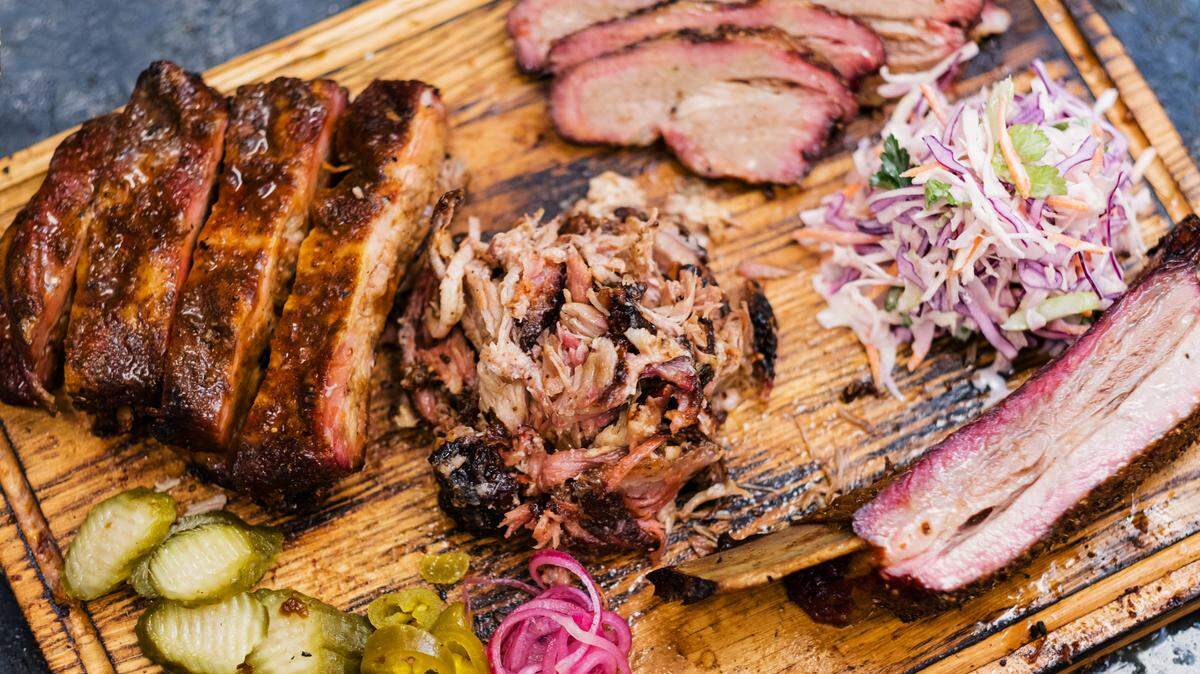 All the Georgia barbecue staples: sliced beef brisket, pulled pork, ribs, coleslaw salad, pickles.