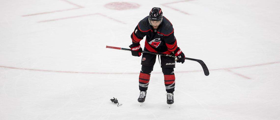 Carolina Hurricanes defenseman Shaye Gostisbehere (04) skates by a rat, a symbol of victory thrown on the ice by Florida Panthers fans, following their 5-3 victory over the Hurricanes on Wednesday, May 28, 2025 at Lenovo Center in Raleigh, N.C.