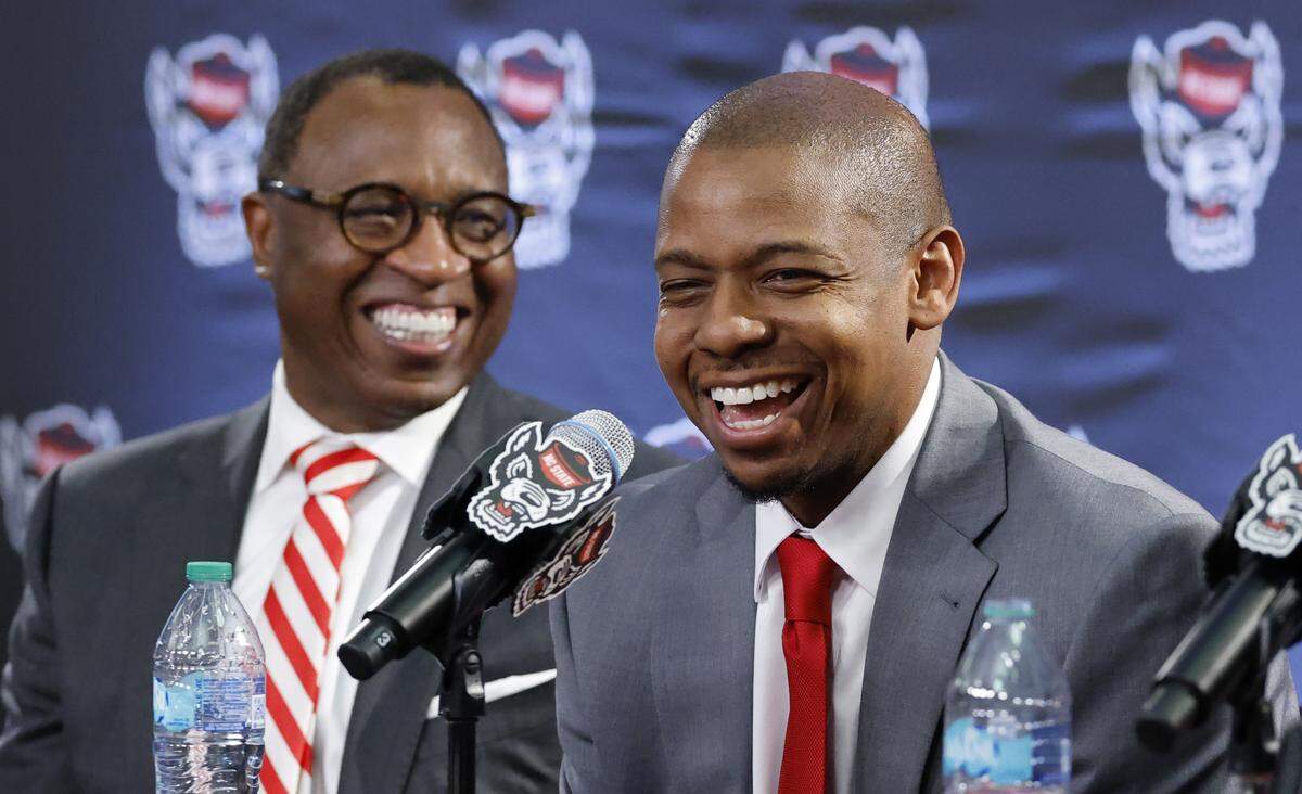 New N.C. State head men’s basketball coach Justin Gainey and Chancellor Kevin Howell laugh during press conference at the Lenovo Center in Raleigh, N.C., where Gainey was officially introduced as head coach Wednesday, April 1, 2026.