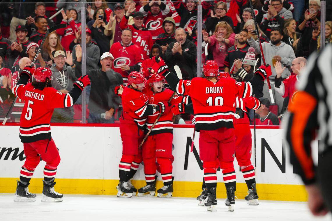 Oct 15, 2024; Raleigh. Carolina Hurricanes right wing Jackson Blake (53) celebrates his goal with Carolina Hurricanes defenseman Dmitry Orlov (7) against the New Jersey Devils during the third period at Lenovo Center. Mandatory Credit: James Guillory-Imagn Images