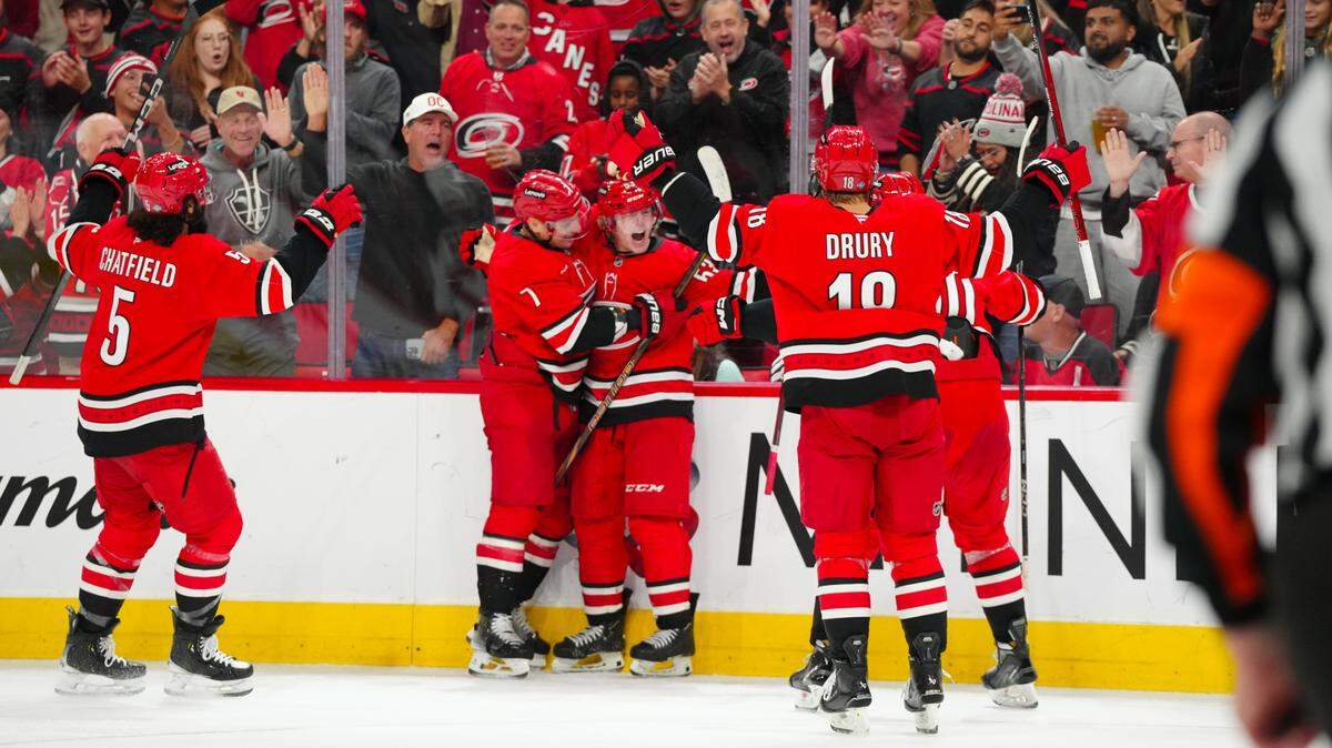 Oct 15, 2024; Raleigh, North Carolina, USA; Carolina Hurricanes right wing Jackson Blake (53) celebrates his goal with Carolina Hurricanes defenseman Dmitry Orlov (7) against the New Jersey Devils during the second period at Lenovo Center. Mandatory Credit: James Guillory-Imagn Images