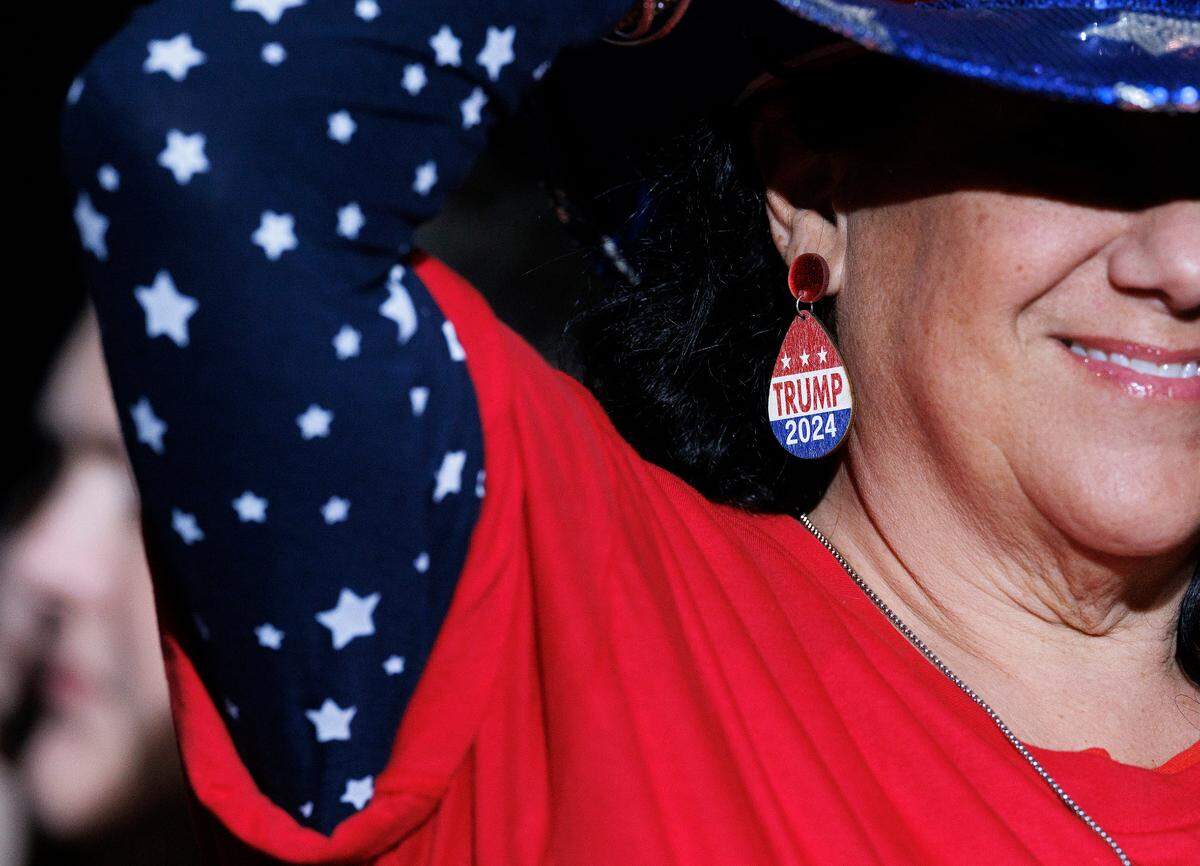 Marla Ritter wears earrings in support of former President and Republican presidential candidate Donald Trump during a campaign rally at the Greensboro Coliseum Complex on Tuesday, Oct. 22, 2024, in Greensboro, N.C.