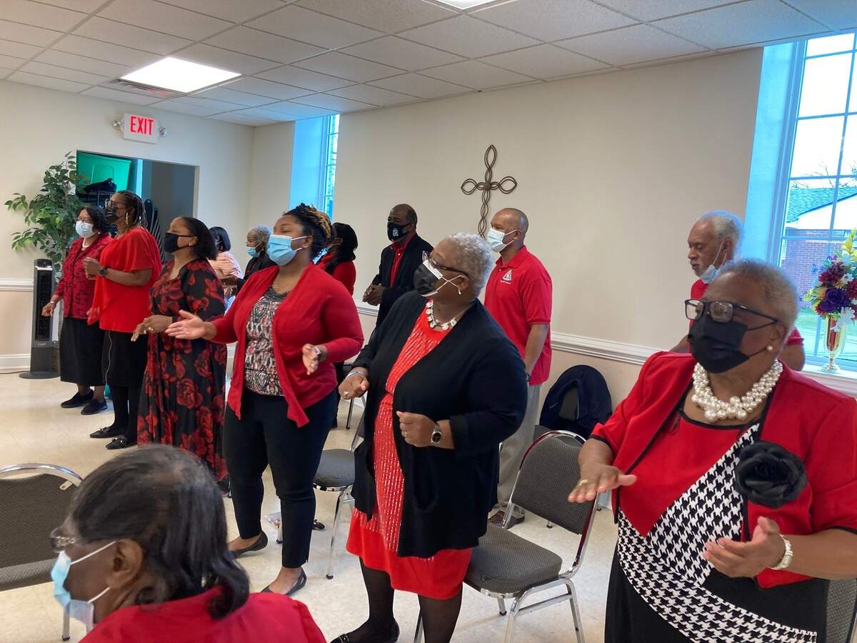 The choir at Mount Lebanon AME Zion Church sings during Sunday morning service on April 25, 2021, including Kiera Gilliam, who has her hands spread in the front row. Civil rights leaders held a press conference at the church on Saturday calling for justice in the police shooting death of Andrew Brown, Jr.