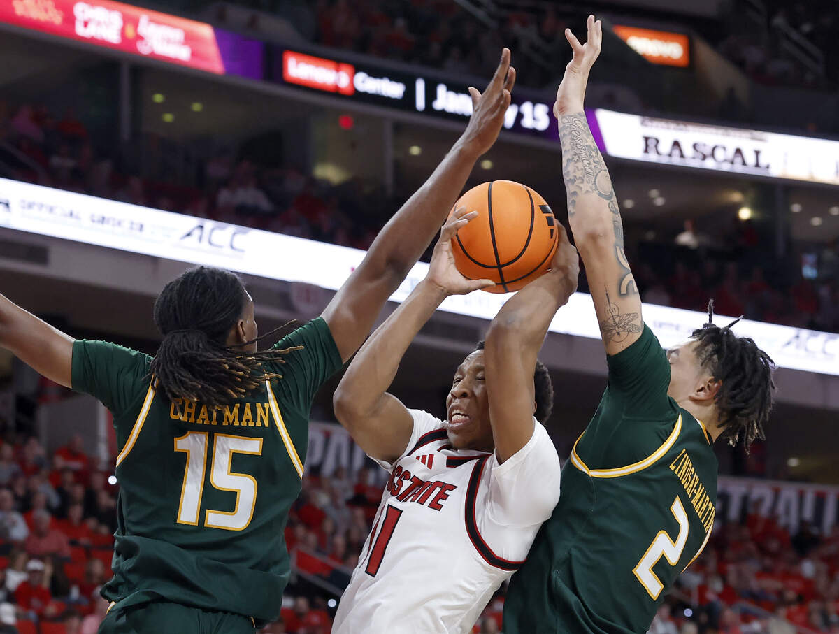 N.C. State’s Quadir Copeland drives between UAB’s Evan Chatman and Kyeron Lindsay-Martin during the first half of the Wolfpack’s game at Lenovo Center on Friday, Nov. 7, 2025, in Raleigh, North Carolina.