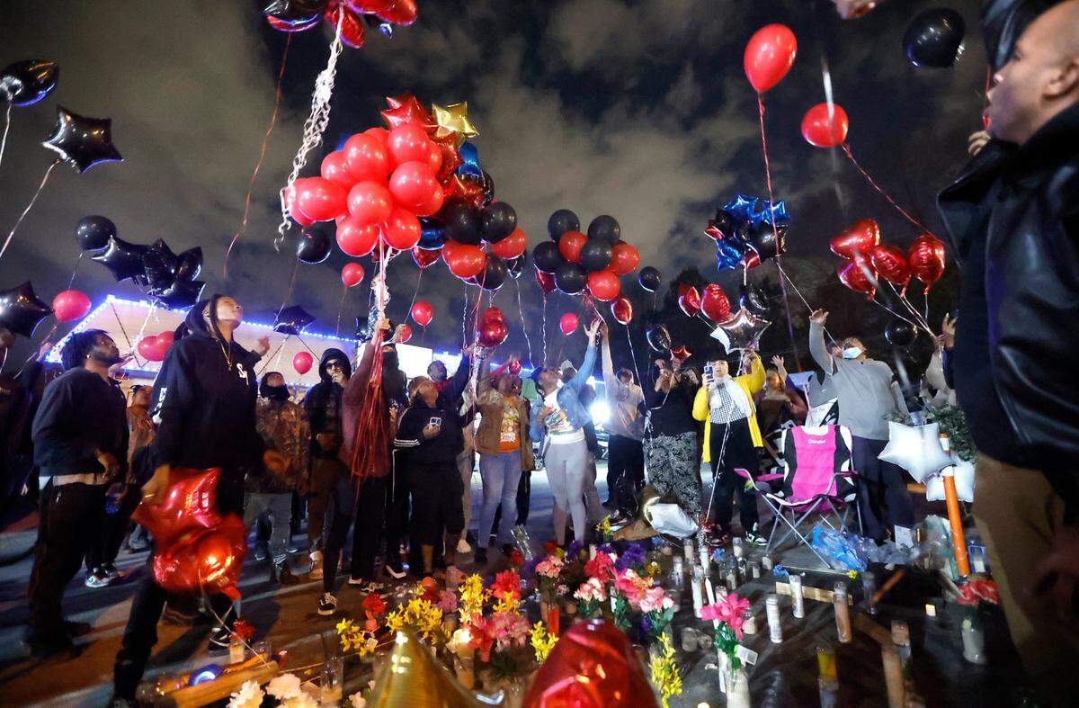 As attendees say “we love you boo-boo” balloons are released during a vigil for Darryl Williams outside Supreme Sweepstakes in Raleigh, N.C., Thursday evening, Jan. 19, 2023. Williams, 32, died after he was tased by Raleigh police officers Tuesday morning.