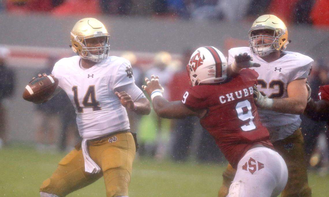 Notre Dame quarterback DeShone Kizer (14) tries to escape N.C. State defensive end Bradley Chubb (9) as Notre Dame offensive lineman Colin McGovern (62) blocks during the first half of the Wolfpack’s game against Notre Dame at Carter-Finley Stadium in Raleigh, N.C., Saturday, Oct. 8, 2016.