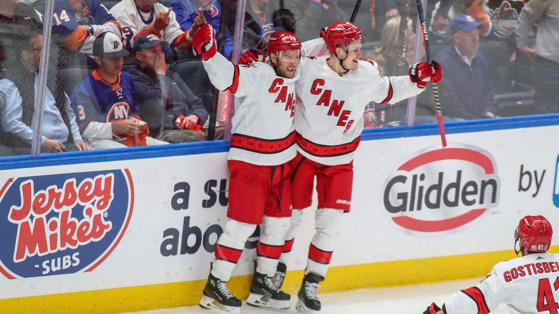 Carolina Hurricanes center Paul Stastny (26) celebrates with right wing Jesse Puljujarvi (13) after scoring the game-winning goal in overtime to defeat the New York Islanders 2-1 in game six of the first round of the 2023 Stanley Cup Playoffs at UBS Arena.