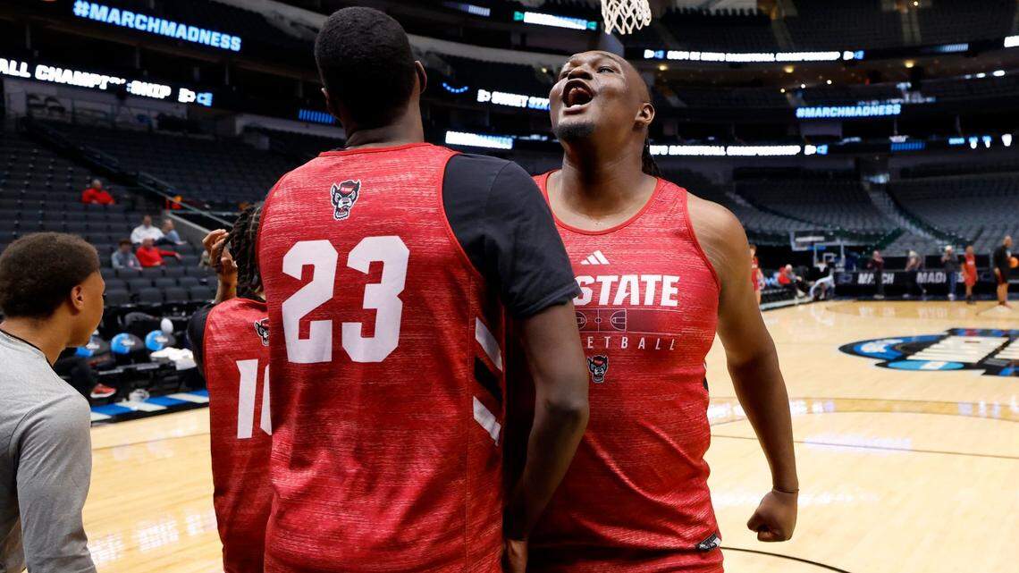 N.C. State’s DJ Burns Jr. (30) bumps chests with Mohamed Diarra (23) during the Wolfpack’s practice at the American Airlines Center in Dallas on March 28.