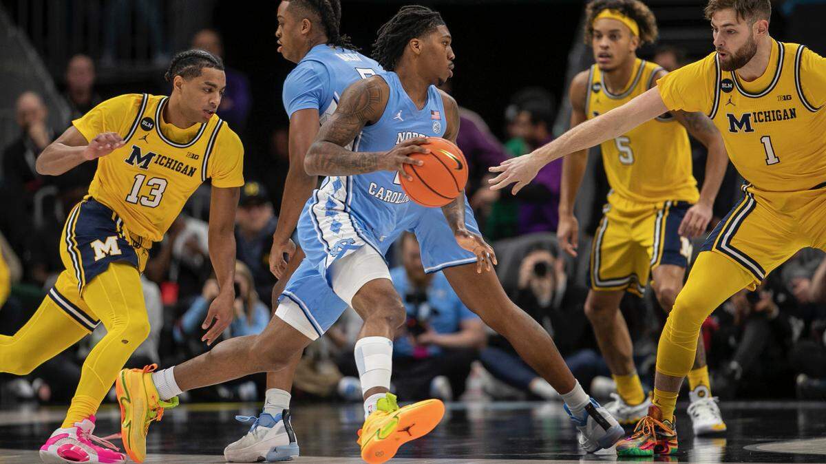 North Carolina’s Caleb Love (2) works around a screen by Armando Bacot (5) during the Tar Heels’ game against Michigan on Wednesday, December 21, 2022 at the Spectrum Center in Charlotte, N.C.