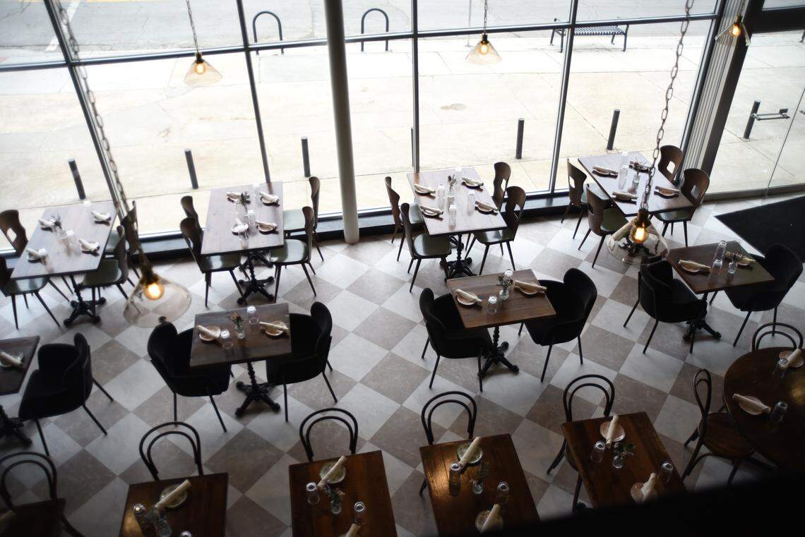 The view from the upstairs mezzanine lounge looks down on the Delancey Tavern dining room.
