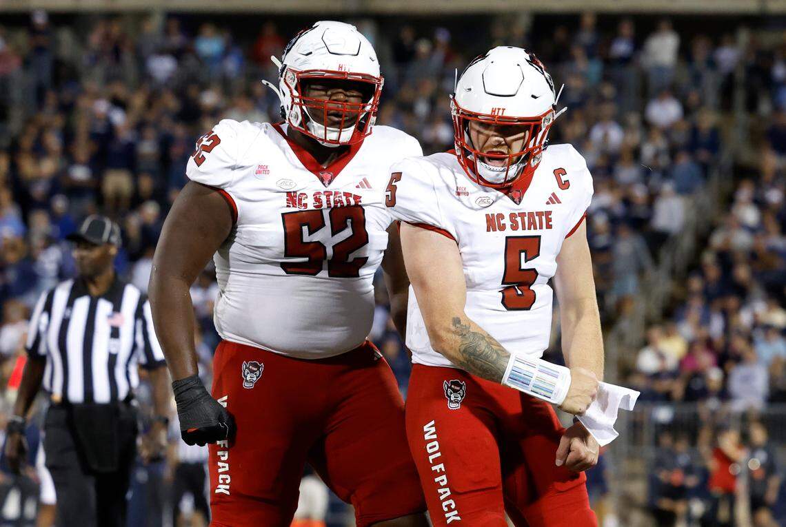 N.C. State quarterback Brennan Armstrong (5) and offensive lineman Timothy McKay (52) celebrate after Armstrong scored on four-yard touchdown run during the first half of N.C. State’s game against UConn at Rentschler Field in East Hartford, Conn. Thursday, August 31, 2023.