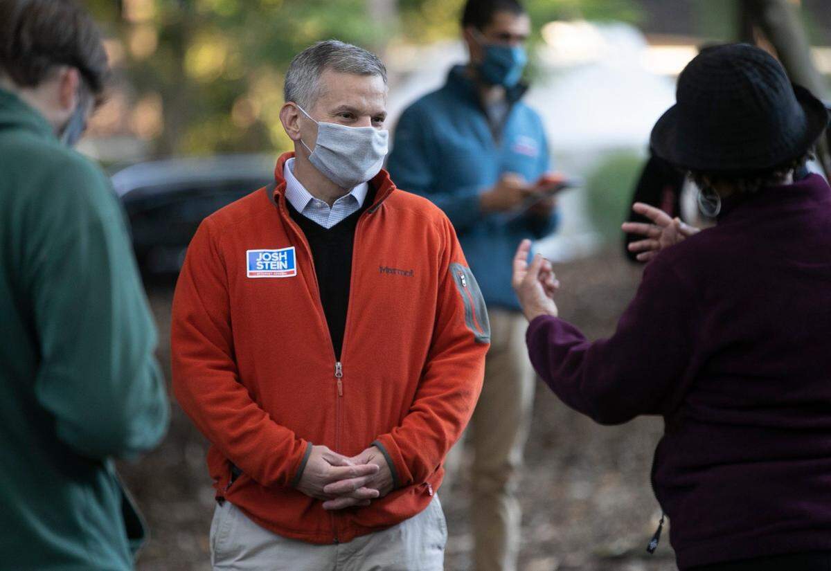 Attorney General Josh Stein talks with voters waiting in line at the Roberts Park early voting site on Thursday morning, October 15, 2020 in Raleigh, N.C.