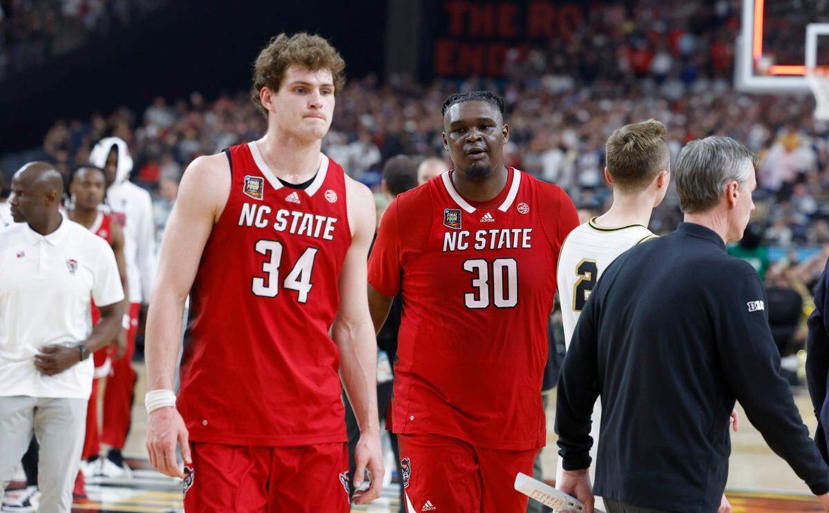 N.C. State’s Ben Middlebrooks (34) and DJ Burns Jr. (30) walk off the court after Purdue’s 63-50 victory over N.C. State in the NCAA Tournament national semifinals at State Farm Stadium in Glendale, Ariz., Saturday, April 6, 2024.