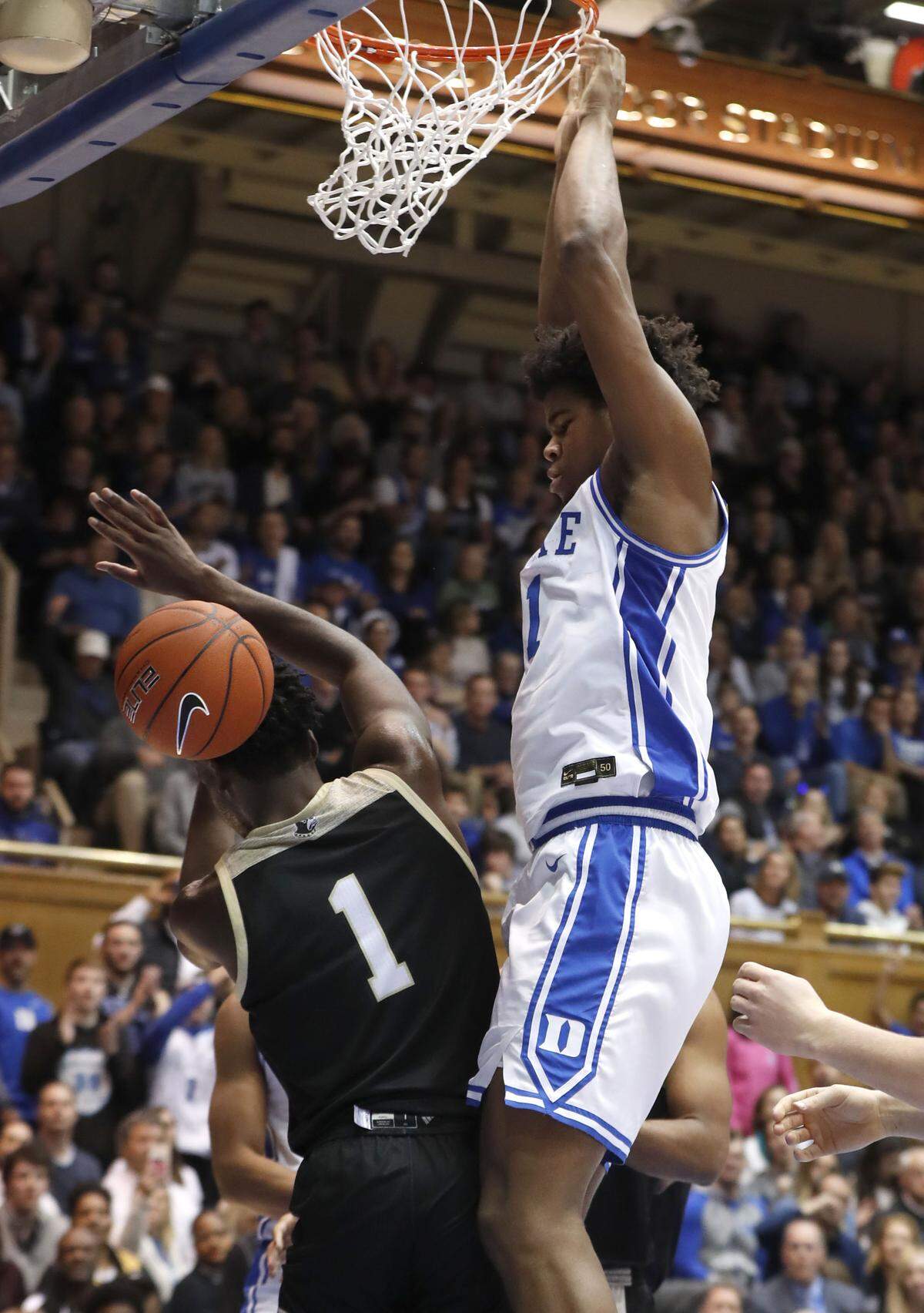 Duke’s Vernon Carey Jr. (1) looks down over Wofford’s Chevez Goodwin (1) after slamming in two during the first half of Duke’s game against Wofford at Cameron Indoor Stadium in Durham, N.C., Thursday, Dec. 19, 2019.