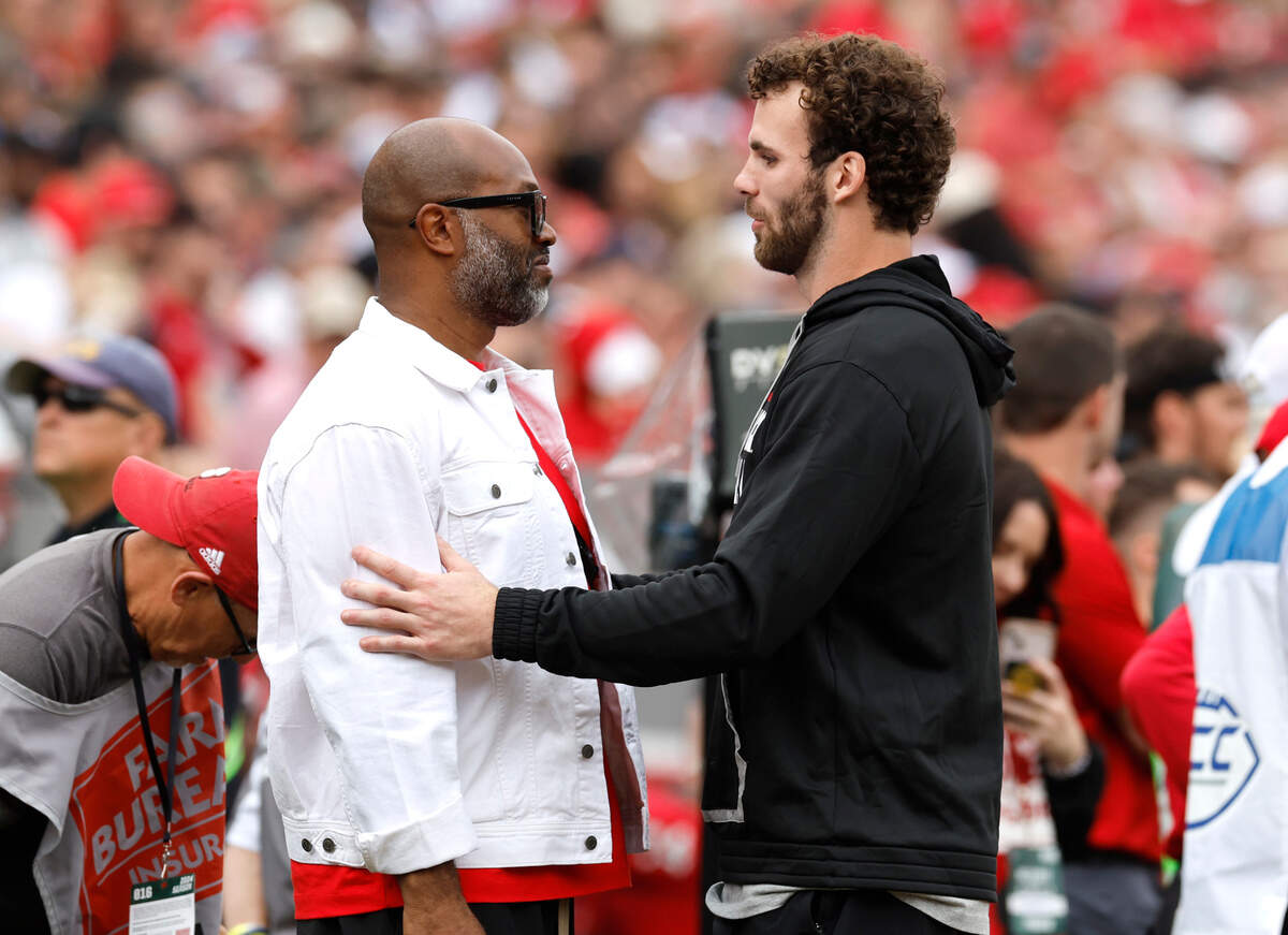 Former N.C. State linebacker Payton Wilson talks with former wide receiver Torry Holt after Wilson was inducted into the Ring of Honor during the Wolfpack’s game against Stanford at Carter-Finley Stadium in Raleigh, N.C., Saturday, Nov. 2, 2024.