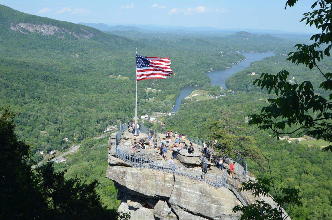 With views across U.S. 64-74A and Lake Lure, Chimney Rock marks the older part of Chimney Rock State Park.