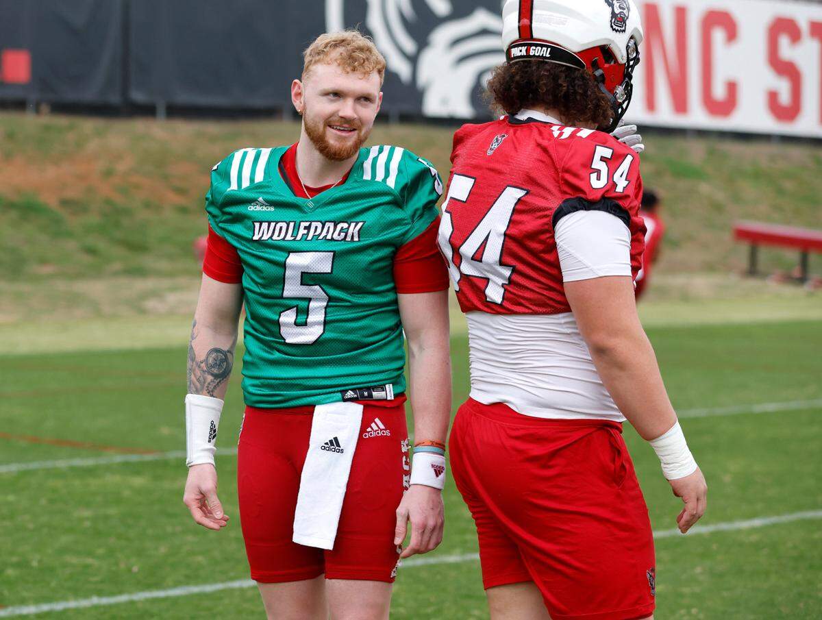 N.C. State quarterback Brennan Armstrong (5) talks with Dylan McMahon (54) during the Wolfpack’s first spring practice in Raleigh, N.C., Wednesday, March 1, 2023.