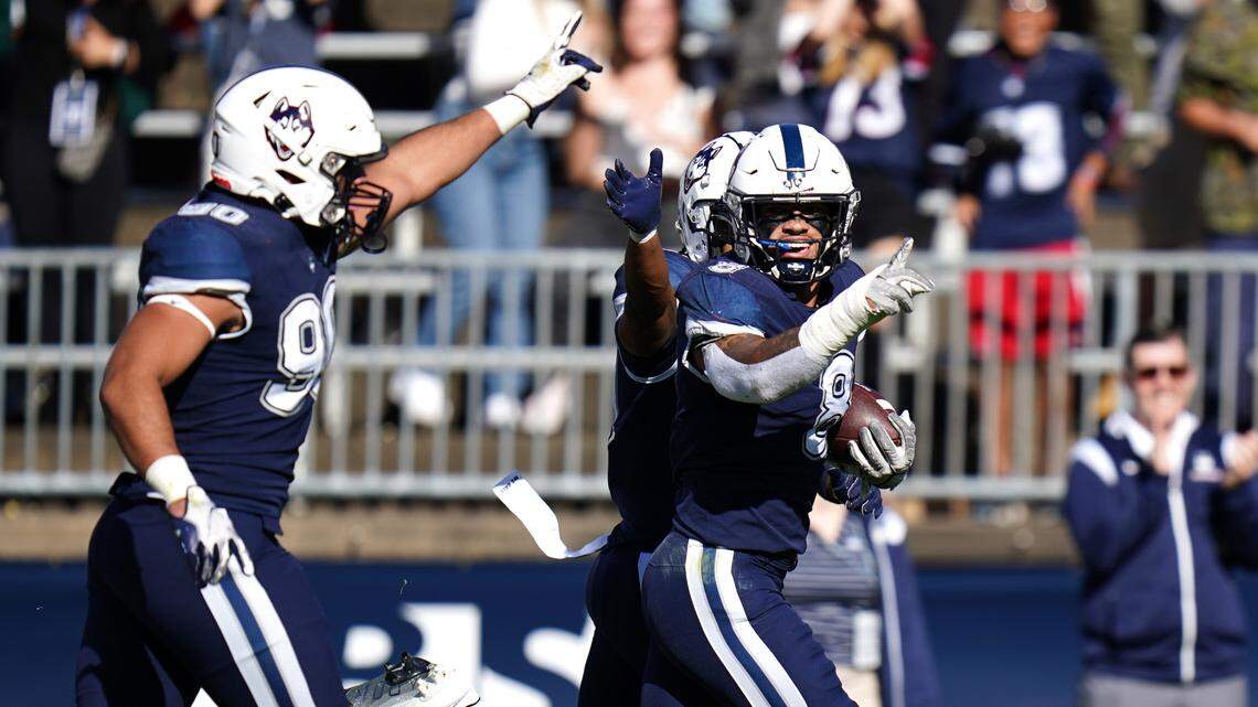 Connecticut Huskies linebacker Jackson Mitchell (8) recovers the fumble and runs for a touchdown during their game against the Liberty Flames in East Hartford, Conn. in Nov. 2022.