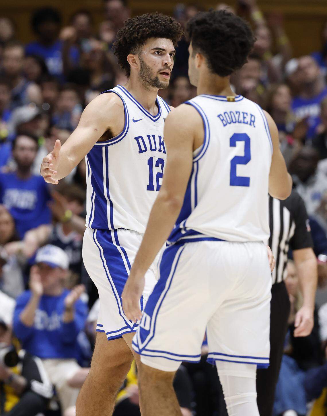 Duke’s Cameron Boozer (12) celebrates with Cayden Boozer (2) during the second half of Duke’s 67-54 victory over Clemson at Cameron Indoor Stadium in Durham, N.C., Sat., Feb. 14, 2026.