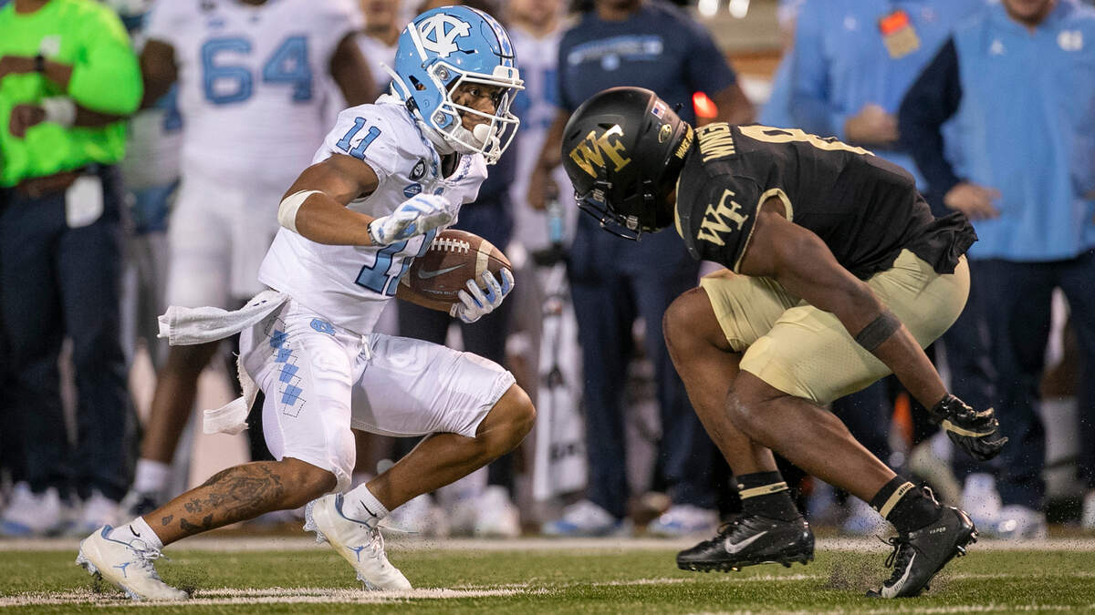 North Carolina’s Josh Downs (11) looks for running room against Wake Forest’s Isaiah Wingfield (8) after a 43-yard pass reception from quarterback Drake Maye in the fourth quarter on Saturday, November 12, 2022 at Truist Field in Winston-Salem, N.C.