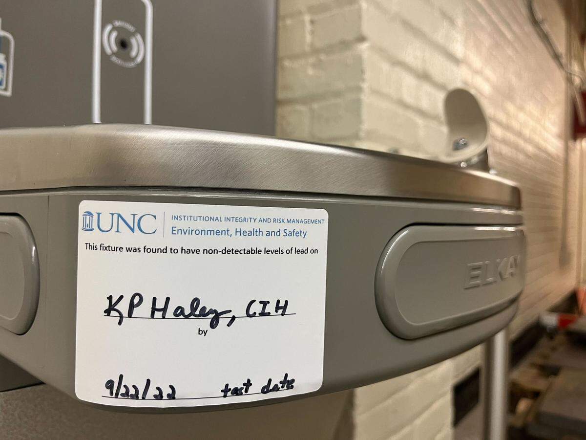 A sticker on a fountain in Phillips Hall on the UNC Chapel Hill campus notes the tester and testing date for detecting lead in the water.