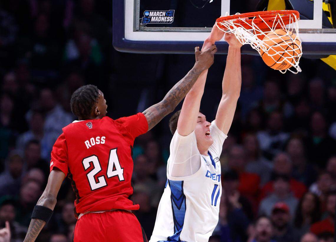 Creighton’s Ryan Kalkbrenner (11) slams in two past N.C. State’s Ernest Ross (24) during the second half of Creighton’s 72-63 victory over N.C. State in the first round of the NCAA Tournament at Ball Arena in Denver, Colo., Friday, March 17, 2023.